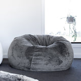fur bean bag in a living room with a cowhide rug