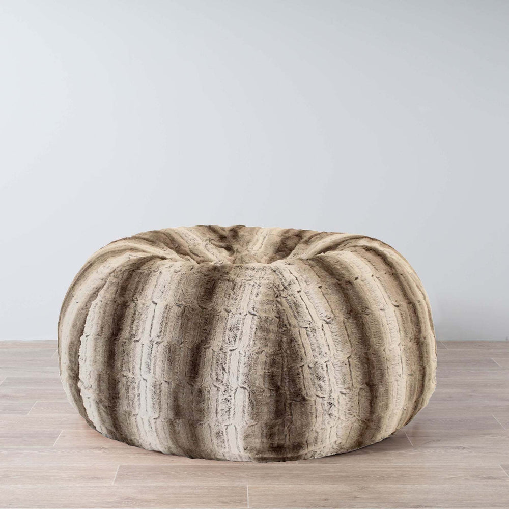 large plush fur beanbag on a wooden floor