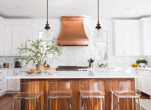 lucy glass pendant lights in a white kitchen with copper accents
