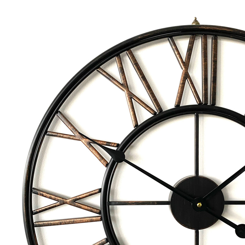 large black bronze metal wall clock on a white background