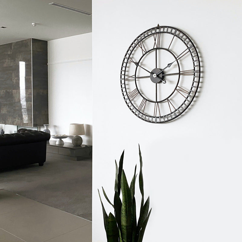 provincial look distressed metal wall clock on a white wall in a modern living room
