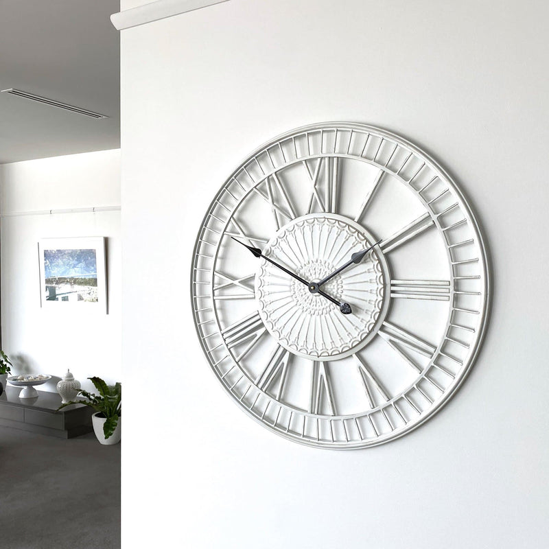 large shabby chic wall clock on a white wall in a living room