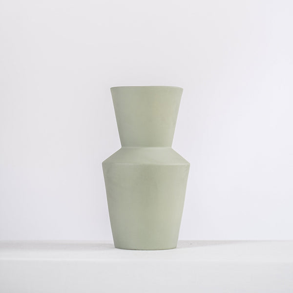 modern sage ceramic vase on a white shelf