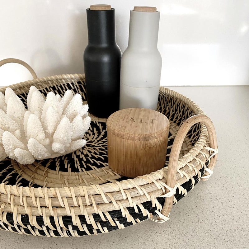  white coral and salt on a large round rattan tray with handles