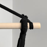 top detail of black and white stripe hammock with cushions and tassels
