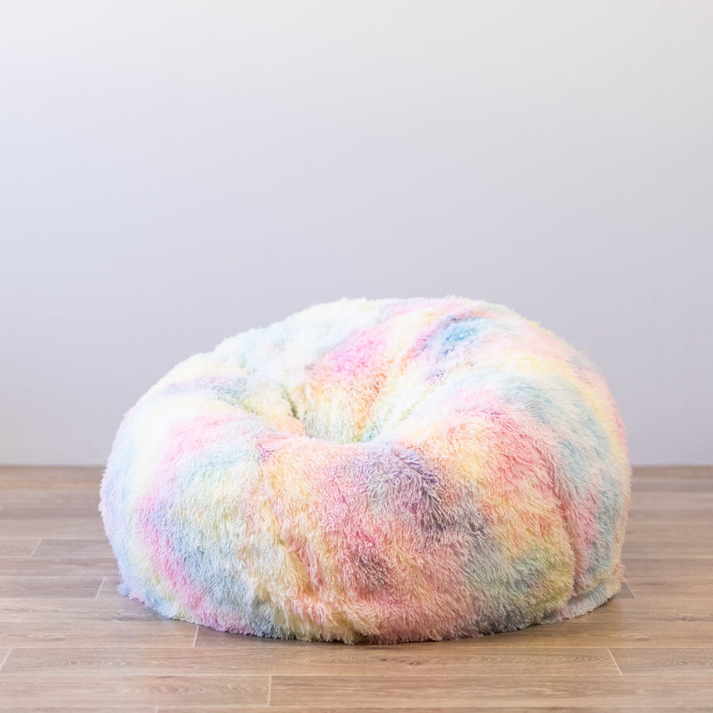 shaggy fur unicorn rainbow beanbag on a wooden floor  Edit alt text
