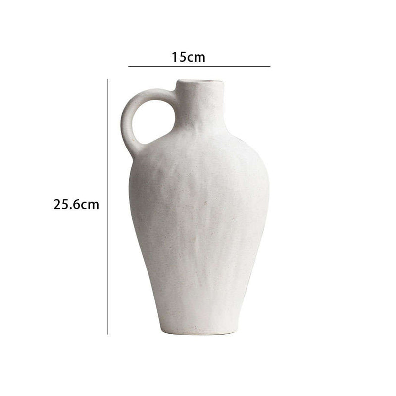 tall white vessel vase on white shelf