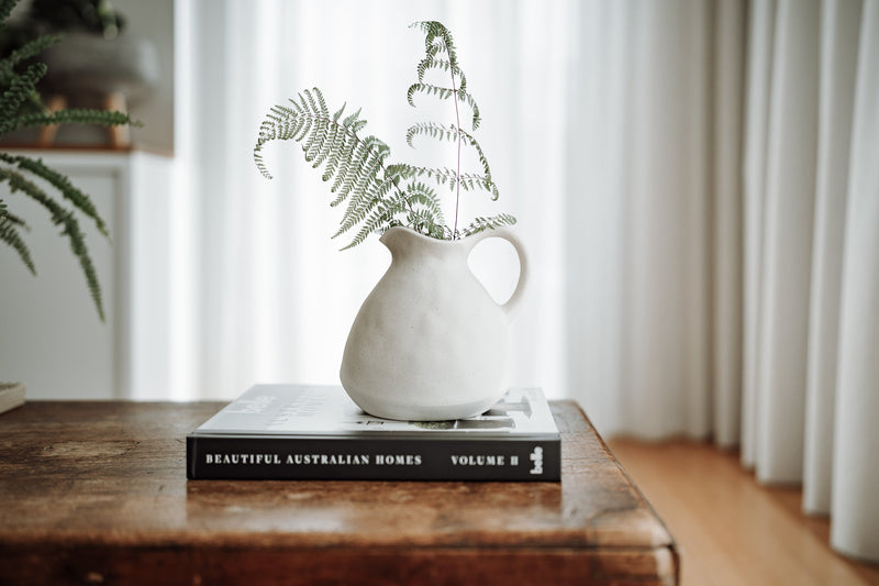ceramic vase vessel on a coffee table book
