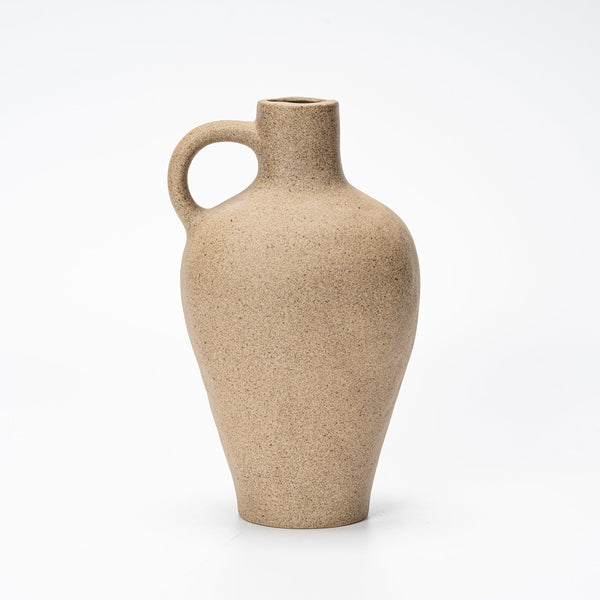 tall clay vessel vase on white shelf