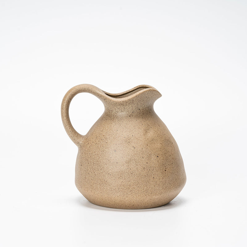 clay jug vase vessel on a white shelf