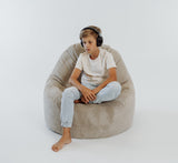 boy sitting on a large fur lounger bean bag