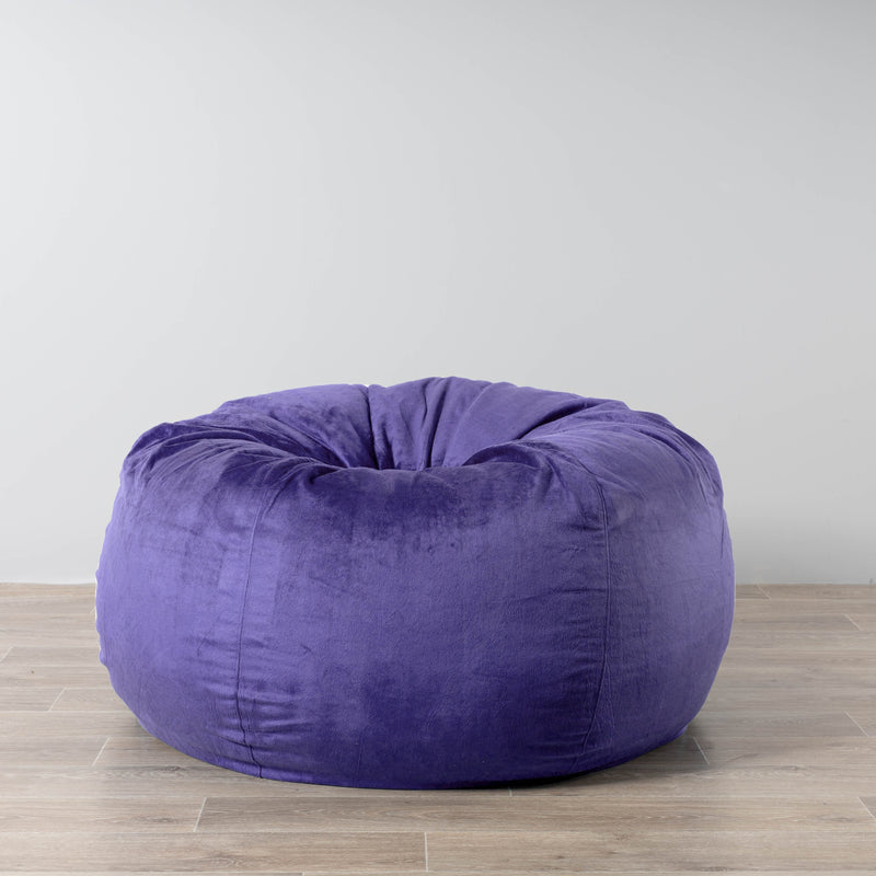 very peri purple velvet large fur beanbag on a wooden floor
