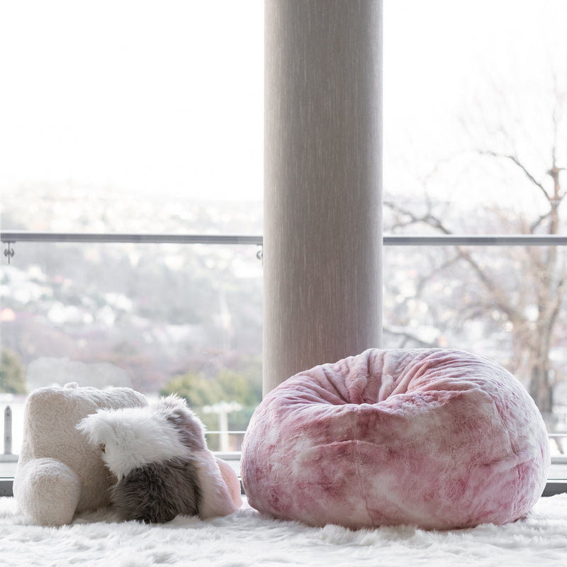 plush pink marble beanbag on a shaggy white rug