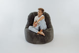 boy relaxing in a plush fur bean bag lounger