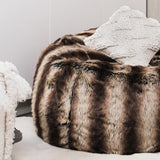 closeup of a fur beanbag on a cowhide rug