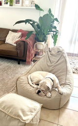 a dog making himself at home on an Ivory & Deene linen beanbag