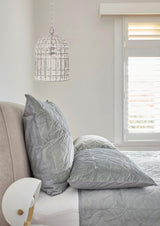 whitney dome chandelier in a bedroom with grey bedding
